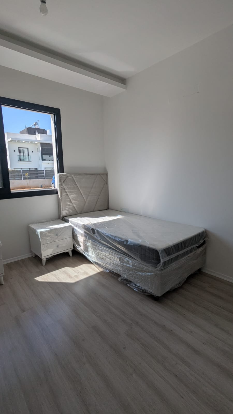 Compact bed with bedside table